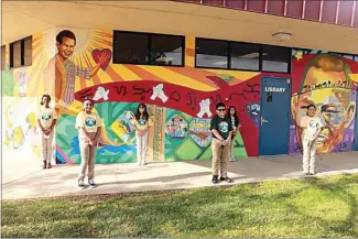  ?? PHOTO BY MIKE BLEDSOE / DUSD ?? Morningsid­e Elementary School’s student body officers pose in front of the Larry Itliong mural on the walls of the renamed Larry D. Itliong Memorial Library. From left are Koumba Diallo, Kaylee Camacho, Arianna Samano, Isaac Barajas, Zyla Ramos and Aleksia Rodriguez Solorio.