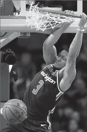  ?? AP/MICHAEL DWYER ?? Bradley Beal (3) of the Washington Wizards dunks in two of his 25 points in the Wizards’ 111-103 victory over the Boston Celtics on Monday. Beal also had eight rebounds.