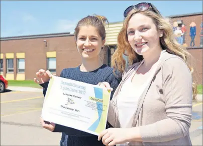  ?? COLIN MACLEAN/JOURNAL PIONEER ?? École Évangéline teacher, Dominique Morency, left, with Grade 12 student Shelaine Gallant holding a poster for their upcoming Honour Run in support of the Canadian Cancer Society.