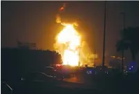  ?? (Hamad I. Mohammed) ?? EMERGENCY WORKERS block a road leading to a fire in an oil pipeline Friday night in Buri, south of Manama, Bahrain.