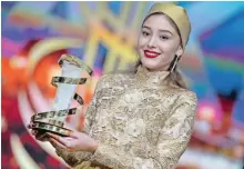  ??  ?? Afghanista­n actress Fereshteh Hosseini holds her trophy after receiving the best actress award.