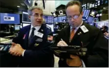  ?? RICHARD DREW — THE ASSOCIATED PRESS FILE ?? Specialist Antony Rinaldi left, and trader Robert Arciero work on the floor of the New York Stock Exchange.