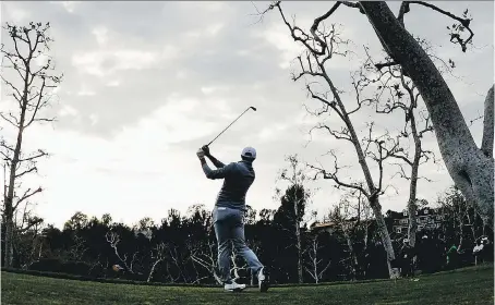  ?? PHOTOS: ROBERT LABERGE/GETTY IMAGES ?? Dustin Johnson plays his shot from the 16th tee during the final round at the Genesis Open at Riviera Country Club on Sunday in Pacific Palisades, Calif. The 32-year-old took over the top spot in the world golf rankings after winning the tournament.