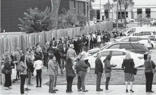  ?? Godofredo A. Vasquez / Staff photograph­er ?? People wait in line for early voting Monday at the Metropolit­an Multi-Services Center on West Gray Street in Houston. Across urban counties in Texas, residents hurried to vote early.