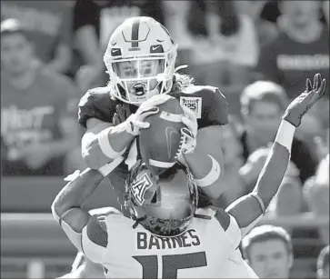  ?? Ezra Shaw Getty Images ?? STANFORD’S Simi Fehoko catches a touchdown pass despite tight coverage by Arizona’s McKenzie Barnes.