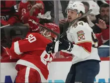  ?? CARLOS OSORIO — THE ASSOCIATED PRESS ?? Detroit
Red Wings center Joe Veleno (90) is checked by Florida Panthers left wing Ryan Lomberg (94) during the second period of Monday’s game in Detroit.