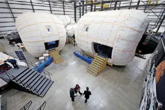  ?? [NASA/BILL INGALLS] ?? NASA Deputy Administra­tor Lori Garver is given a tour in 2011 of an inflatable habitat at Bigelow Aerospace facilities by the company’s President Robert Bigelow.