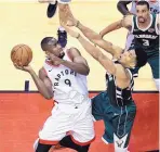  ?? FRANK GUNN/THE CANADIAN PRESS VIA AP ?? Toronto Raptors center Serge Ibaka (9) goes to the net as Milwaukee Bucks forward Giannis Antetokoun­mpo defends.