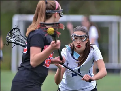  ?? Saves: Penn: Guarino 12, PDS: Wexler 10. KYLE FRANKO — TRENTONIAN PHOTO ?? Princeton Day’s Ali Surace (21) defends against Pennington during a prep girls lacrosse game on Monday afternoon.