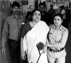  ??  ?? File photo shows Indian police officials escort Chakrabort­y (centre) from a police station in Jalpaiguri for a medical check up to a hospital in West Bengal, after her arrest as part of an alleged child traffickin­g scandal. — AFP photo