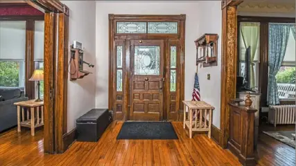 ??  ?? The foyer has all original woodwork, pocket doors and hardwood floors.