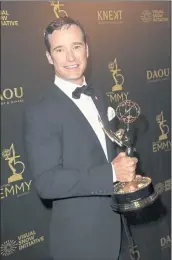  ?? DAVID LIVINGSTON — GETTY IMAGES — TNS ?? Mike Richards holds the Outstandin­g Game Show award for “The Price is Right” at the 45th annual Daytime Emmy Awards at Pasadena Civic Auditorium on in Pasadena