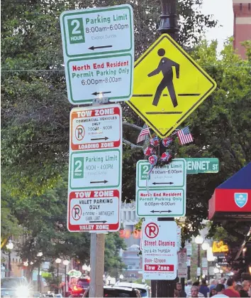  ?? STAFF PHOTO BY CHRIS CHRISTO ?? CAR CHAOS: Parking signs along Hanover Street in the North End could be among those targeted for a digital database makeover.