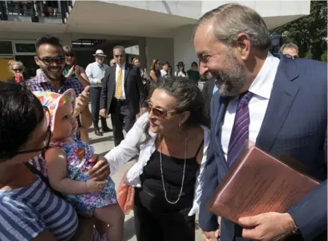  ?? RYAN REMIORZ/THE CANADIAN PRESS ?? NDP Leader Thomas Mulcair and his wife, Catherine Pinhas, greet supporters during a campaign stop in Montreal on Tuesday.