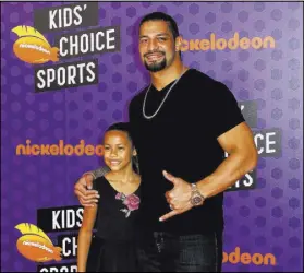  ?? Willy Sanjuan The Associated Press ?? Roman Reigns, aka Leati Joseph Anoa’i, and daughter Joelle Anoa’i at the Kids’ Choice Sports Awards in July in Santa Monica, Calif.