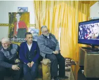  ?? (Ammar Awad/Reuters) ?? RELATIVES OF Abdel Fatah al-Sharif watch the TV broadcast of Sgt. Elor Azaria’s sentencing hearing yesterday in Hebron.