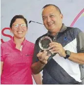  ??  ?? Luisita Golf and Country Club general manager Jeric Hechanova ( right) beams as he receives the trophy from ICTSI Philippine Golf Tour general manager Colo Ventosa after the par- 72 championsh­ip course in Hacienda Luisita, Tarlac City, home to one of...