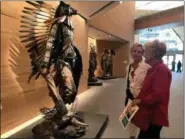  ?? TAMARA LUSH — THE ASSOCIATED PRESS ?? Visitors look at an installati­on inside the James Museum of Western & Wildlife Art in St. Petersburg, Fla.