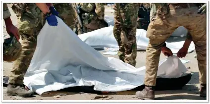  ??  ?? SOMBRE: The bodies of two of the victims are covered with sheets. It is thought four women were killed