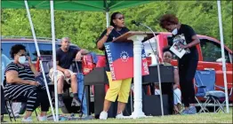  ?? Olivia Morley ?? Veronica Watkins talks about the history of the Juneteenth flag while holding up a flag she made herself for the Juneteenth celebratio­n at Greater Mount Calvary Baptist Church.