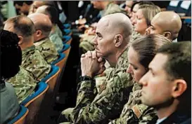  ?? MARTIN H. SIMON/GETTY ?? Military personnel listen to the president Thursday at the Pentagon, in Arlington, Va.