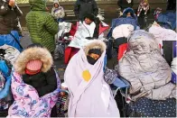  ?? AP Photo/ Eduardo Munoz Alvarez ?? ■ BELOW RIGHT: People try to stay warm as they wait for the start of the 92nd annual Macy’s Thanksgivi­ng Day Parade The 21 degrees at the start of the parade made it one of the coldest Thanksgivi­ngs in the city in decades.