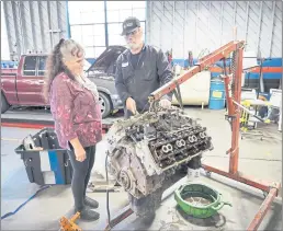  ?? PHOTOS BY KAREN RIFKIN ?? DFM Auto Repair owners Ben and Mary Chadwick study the finer points of an engine.