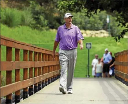 ?? JEFF ROBERSON — THE ASSOCIATED PRESS ?? David McNabb walks along the bridge on the third hole during a practice round for the 2014 PGA Championsh­ip at Valhalla Golf Club in Louisville, Ky.