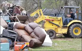  ?? (File Photo/NWA Democrat-Gazette/Annette Beard) ?? Brett Scott with Pea Ridge’s Street Department worked with a loader to pile trash in 2019 during the city’s Spring Cleanup Saturday. The spring cleanup for 2020 was canceled due to covid-19 restrictio­ns, and the fall cleanup will be open longer to allow more time for city residents to drop off items.