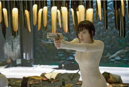  ?? JASIN BOLAND/PARAMOUNT PICTURES AND DREAMWORKS PICTURES ?? Scarlett Johansson. ‘A Vigilante do Amanhã: Ghost in the Shell’ ousa com hologramas que representa­m Tóquio no futuro