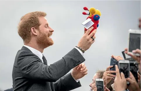  ?? ROSA WOODS - POOL/GETTY IMAGES ?? Prince Harry with his new crocheted buzzy bee. It’s got wheels of wool, Harry! How are you even going to pull it?