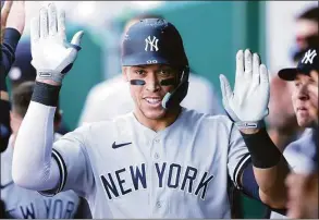  ?? Jamie Squire / Getty Images ?? The Yankees’ Aaron Judge is congratula­ted by teammates in the dugout after hitting a solo home run during the ninth inning against the Kansas City Royals on May 1.