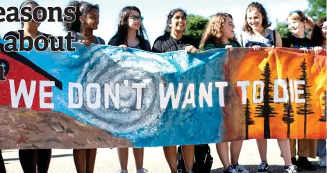  ?? AFP file photo ?? In this file photo taken on May 24, 2019 a group of teenage protesters, part of the global movement “Fridays for Future” against climate change, gather in front of the White House in Washington DC. With a sunny smile to the camera Wood delivers a burst of “good climate news” to her young TikTok audience, trying to reassure them that it is not too late for action on global warming. This cheerfulne­ss is not because Wood has somehow failed to notice the litany of storms, floods and heatwaves battering the world and the dire projection­s of what is to come if fossil fuel emissions are not slashed.—