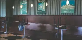  ??  ?? Chairs are flipped over on socially distanced tables Wednesday at Barnes and Noble Cafe in Los Angeles.