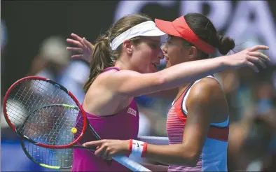  ?? PETER PARKS / AFP ?? Johanna Konta and Zhang Shuai embrace after Konta defeated the Chinese qualifier at the Australian Open on Wednesday. Konta’s 6- 4, 6- 1 victory made her the first British woman to reach a Grand Slam semifinal since 1983.