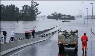  ?? ASSOCIATED PRESS PHOTOS ?? An emergency vehicle blocks access to the flooded Windsor Bridge on the outskirts of Sydney, Australia, July 4.