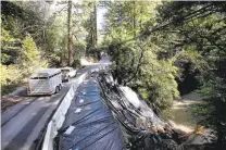  ?? KARLMONDON/STAFF ?? Motorists share the remaining lane on storm-damaged Bear Creek Road on March 5 in Boulder Creek, where more than 80 inches of rain has fallen this winter.