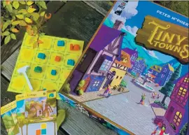  ?? PHOTOS BY JACKIE BURRELL ?? TINY TOWNS: Players are builders, striving to create perfect little villages for the creatures who inhabit them, in a game that relies on careful planning and Tetris-style strategy.