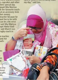  ??  ?? Tears of joy: Erny Liana is emotional after receiving gifts from her pupils.