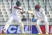  ??  ?? Bangladesh’s Shadman plays a shot as WI’s wicketkeep­er Shane Dowrich looks on during Day 1 of the second Test on Friday