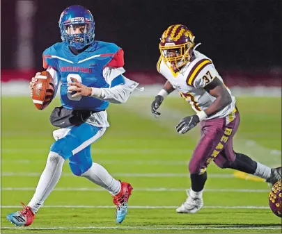  ?? SEAN D. ELLIOT/THE DAY ?? Waterford quarterbac­k Ryan Bakken, left, eludes Granby/Canton’s Donte’l Williams in Wednesday’s CIAC Class M quarterfin­al.