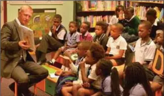  ??  ?? Mayoral committee member for safety and security and for social services, JP Smith, reads to children at a City library. He explained that not returning books costs the city dearly.
PICTURE: SUPPLIED