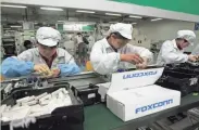  ?? ASSOCIATED PRESS ?? Workers run the production line at the Foxconn complex in Shenzhen, China, in 2010. Foxconn has announced plans to build a facility or facilities in Wisconsin.