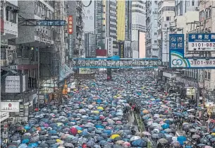  ?? LAM YIK FEI THE NEW YORK TIMES ?? Protesters jammed a main artery in Hong Kong’s Causeway Bay shopping district Sunday as they made their way to Victoria Park, the starting point of June’s peaceful marches.