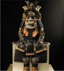  ?? ?? This set of samurai armour includes mitten-shaped iron coverings to protect the hands and feet. Samurai Museum