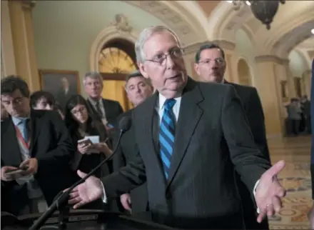  ?? J. SCOTT APPLEWHITE — THE ASSOCIATED PRESS ?? Senate Majority Leader Mitch McConnell, R-Ky., flanked by Sen. Cory Gardner, R-Colo., left rear, and Sen. John Barrasso, R-Wyo., right rear, talks to reporters Tuesday on Capitol Hill in Washington.