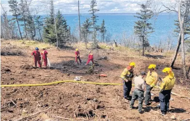  ?? IAN FAIRCLOUGH • SALTWIRE ?? Firefighte­rs from Halls Harbour and two other department­s were called to a woods fire in the community May 8.