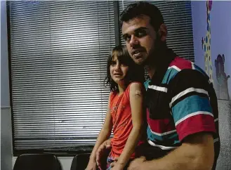  ?? Firestarte­r ?? Youssof al-Mosleh and one of his daughters wait for treatment at Houston’s Hope Clinic.