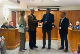  ?? SUSAN L. SERBIN - MEDIANEWS GROUP ?? Swarthmore Borough Council pauses to honor Brian Craig upon his retirement after 20 years as chief of police in the borough. From left are Pauline Craig, Brian Craig, former mayor and state Sen. Tim Kearney, and Mayor Marty Spiegel.