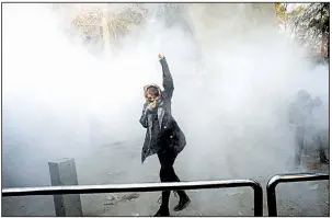  ?? AP ?? An Iranian student braves a police smoke grenade Saturday during a protest at Tehran University.